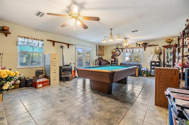 2308 Rio Cir, Spring Hill, FL 34608 - recreation room featuring ceiling fan, a textured ceiling, plenty of natural light, a wood stove, and billiards table