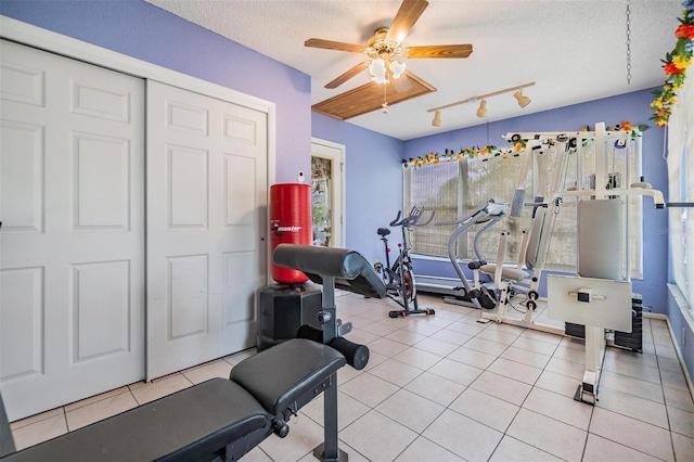 2308 Rio Cir, Spring Hill, FL 34608 - workout area featuring a ceiling fan, a textured ceiling, track lighting, and tile patterned floors