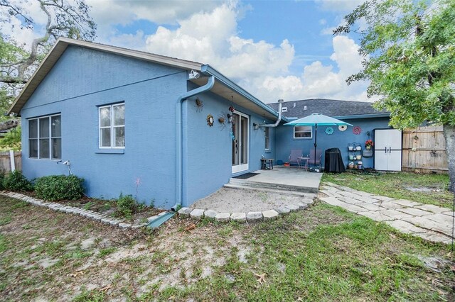 2308 Rio Cir, Spring Hill, FL 34608 - back of house with a patio area, fence, and stucco siding