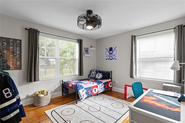 bedroom with wood finished floors and baseboards