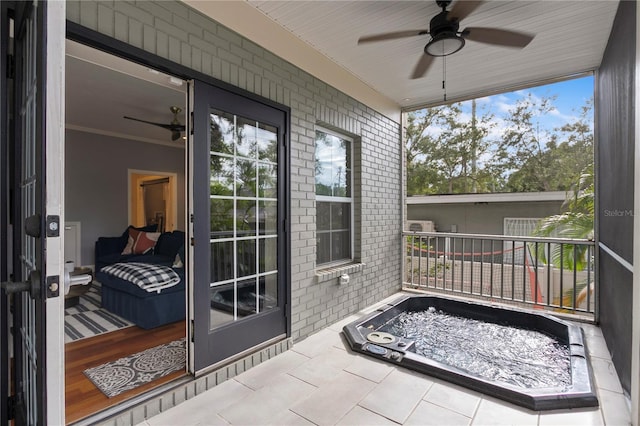 sunroom with a ceiling fan