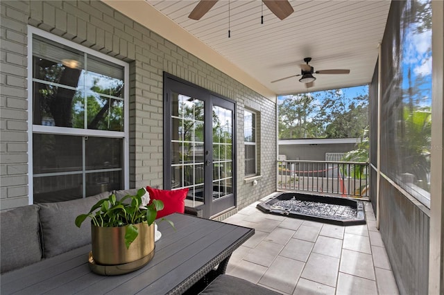 sunroom / solarium with a ceiling fan, healthy amount of natural light, and outdoor dining space