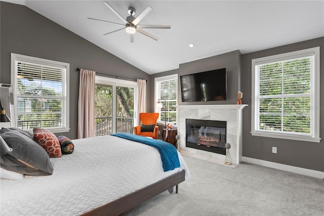 carpeted bedroom featuring access to exterior, lofted ceiling, a fireplace, baseboards, and multiple windows