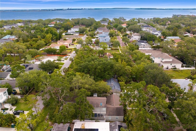 aerial view of property's location with nearby suburban area and a nearby body of water