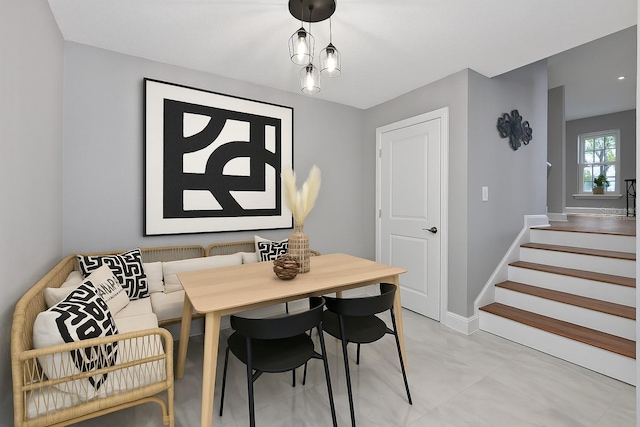 dining area featuring stairway and baseboards
