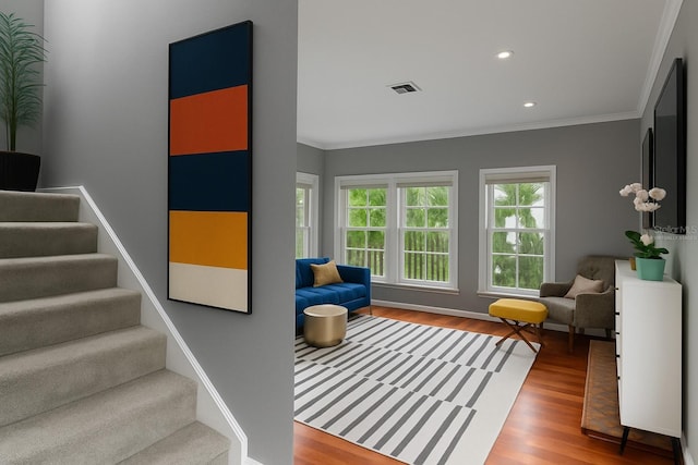 living room featuring stairway, wood finished floors, crown molding, and recessed lighting