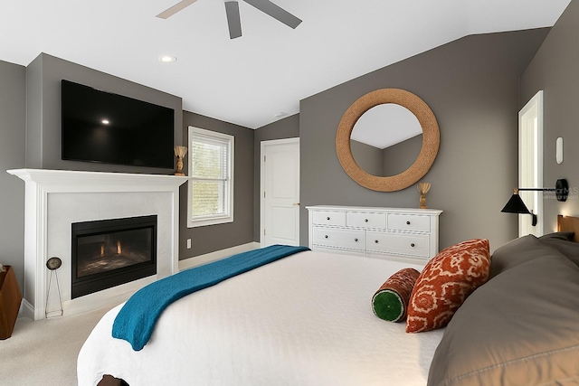 carpeted bedroom with vaulted ceiling, baseboards, a ceiling fan, recessed lighting, and a glass covered fireplace