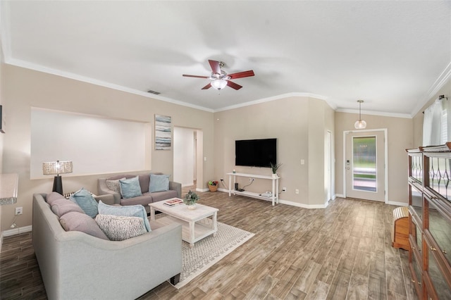 7103 Bridgeview Dr, Wesley Chapel, FL 33545 - living area with wood finished floors, ceiling fan, baseboards, and ornamental molding