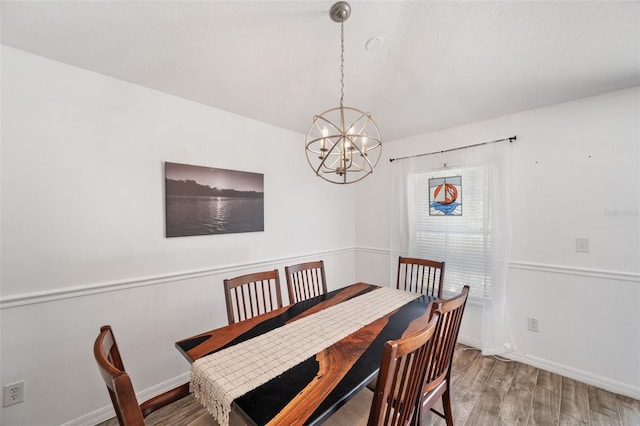 7103 Bridgeview Dr, Wesley Chapel, FL 33545 - dining space featuring a chandelier, wood finished floors, and baseboards