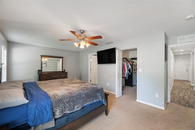 7103 Bridgeview Dr, Wesley Chapel, FL 33545 - bedroom featuring baseboards, light colored carpet, a walk in closet, ceiling fan, and a closet