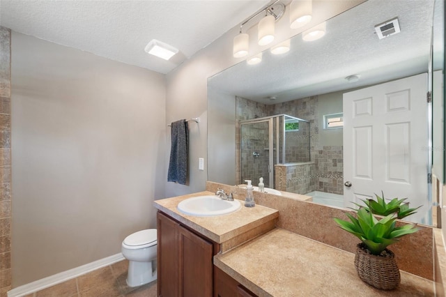 7103 Bridgeview Dr, Wesley Chapel, FL 33545 - bathroom featuring vanity, a shower stall, toilet, a textured ceiling, and tile patterned flooring