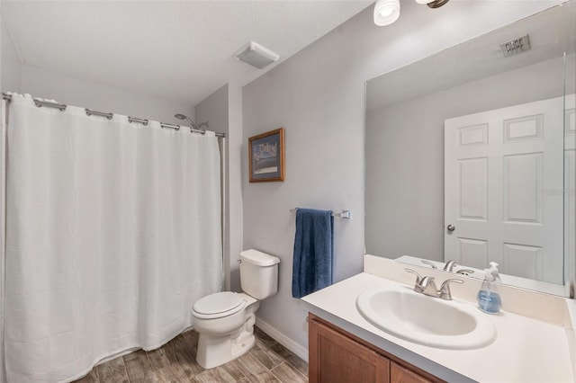 7103 Bridgeview Dr, Wesley Chapel, FL 33545 - bathroom featuring toilet, vanity, wood finished floors, baseboards, and curtained shower