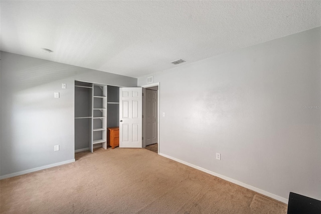 7103 Bridgeview Dr, Wesley Chapel, FL 33545 - unfurnished bedroom with light carpet, baseboards, a textured ceiling, and a closet
