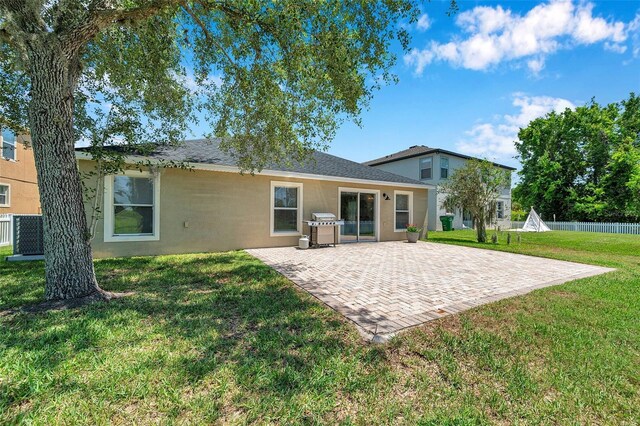 7103 Bridgeview Dr, Wesley Chapel, FL 33545 - back of property featuring a patio and central air condition unit