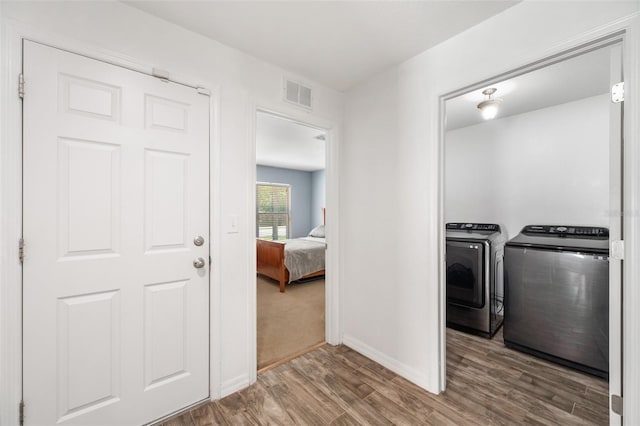 7103 Bridgeview Dr, Wesley Chapel, FL 33545 - washroom featuring wood finished floors, washing machine and clothes dryer, and baseboards