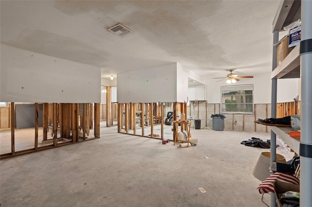 701 59th Ave NE, Saint Petersburg, FL 33703 - unfurnished living room featuring a ceiling fan and concrete flooring