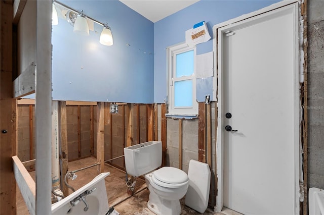 701 59th Ave NE, Saint Petersburg, FL 33703 - bathroom featuring toilet and concrete block wall