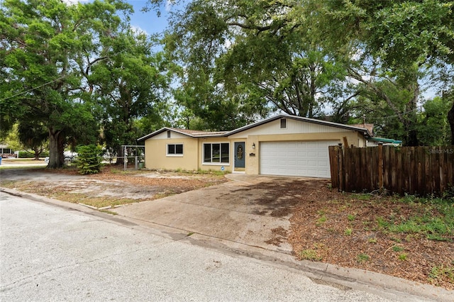 701 59th Ave NE, Saint Petersburg, FL 33703 - single story home with fence, a garage, driveway, and stucco siding