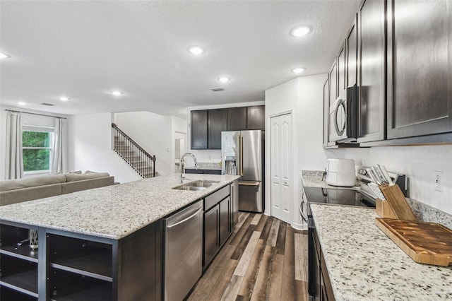 14282 Coronado Dr, Spring Hill, FL 34609 - kitchen with stainless steel appliances, a sink, dark wood finished floors, a kitchen island with sink, and open floor plan