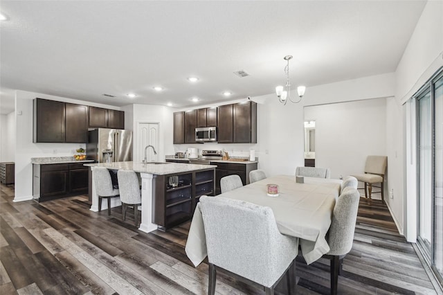 14282 Coronado Dr, Spring Hill, FL 34609 - dining area featuring dark wood finished floors, recessed lighting, a chandelier, and baseboards