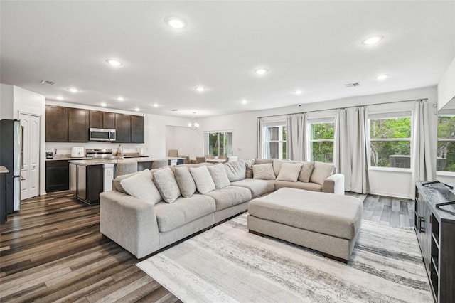 14282 Coronado Dr, Spring Hill, FL 34609 - living room with dark wood-style flooring, recessed lighting, and a chandelier