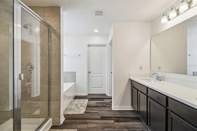 14282 Coronado Dr, Spring Hill, FL 34609 - full bath featuring wood finished floors, a stall shower, vanity, and baseboards