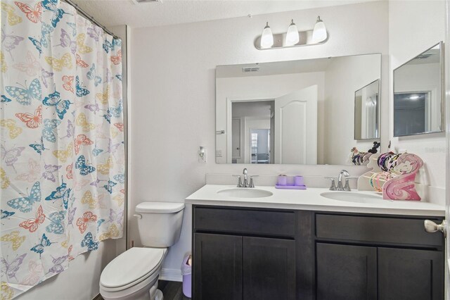 14282 Coronado Dr, Spring Hill, FL 34609 - full bath with toilet, double vanity, and shower / tub combo with curtain