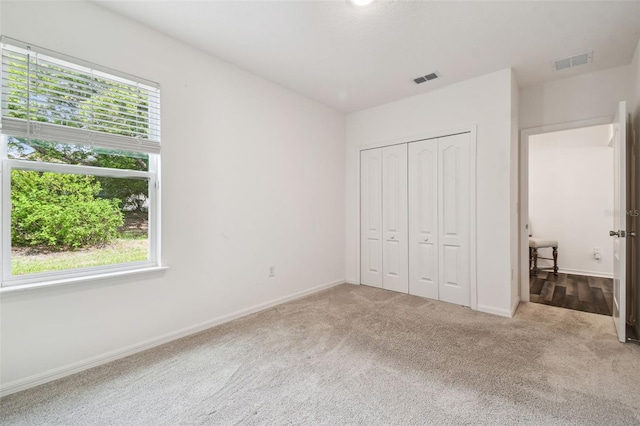 14282 Coronado Dr, Spring Hill, FL 34609 - unfurnished bedroom featuring multiple windows, carpet flooring, and baseboards