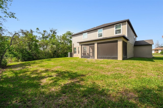14282 Coronado Dr, Spring Hill, FL 34609 - rear view of house featuring a sunroom, a lawn, and cooling unit