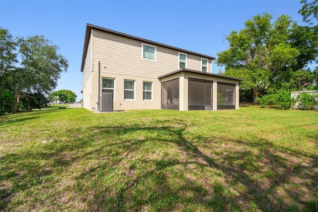 14282 Coronado Dr, Spring Hill, FL 34609 - rear view of property with central air condition unit, a yard, and a sunroom