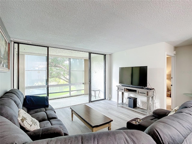 14130 Rosemary Ln Unit 3215, Largo, FL 33774 - living area with wood finished floors, a textured ceiling, and floor to ceiling windows