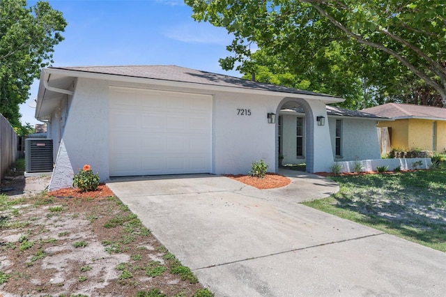 7215 San Moritz Dr, Port Richey, FL 34668 - view of front of property featuring stucco siding, concrete driveway, cooling unit, and fence