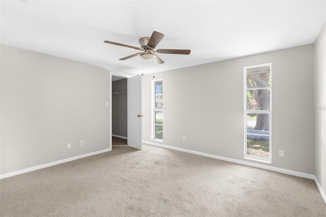 7215 San Moritz Dr, Port Richey, FL 34668 - spare room featuring baseboards, a ceiling fan, healthy amount of natural light, and carpet flooring