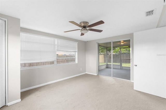 7215 San Moritz Dr, Port Richey, FL 34668 - carpeted empty room with a ceiling fan and baseboards