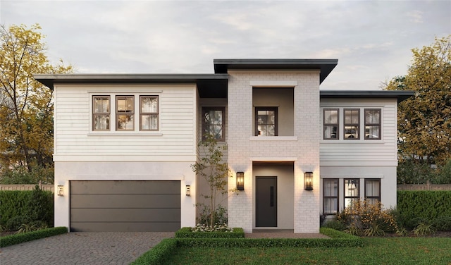 view of front facade featuring driveway, a garage, brick siding, and stucco siding