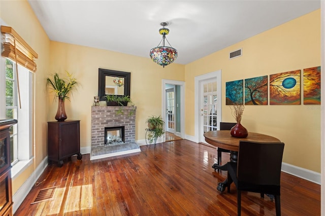1001 E Crawford St, Tampa, FL 33604 - dining space with hardwood / wood-style flooring, a fireplace, and baseboards