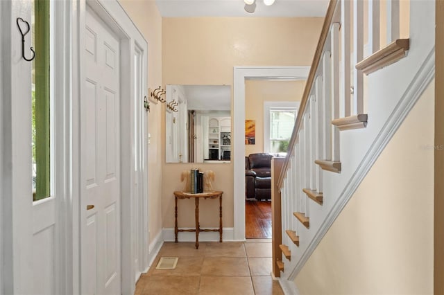 1001 E Crawford St, Tampa, FL 33604 - entryway with light tile patterned floors, stairs, and baseboards