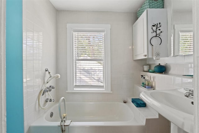 1001 E Crawford St, Tampa, FL 33604 - bathroom with a garden tub, a sink, and tile walls