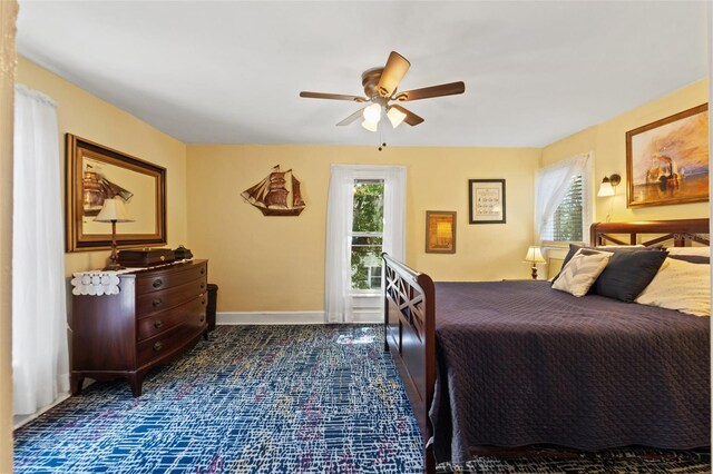 1001 E Crawford St, Tampa, FL 33604 - bedroom with ceiling fan, dark carpet, and baseboards