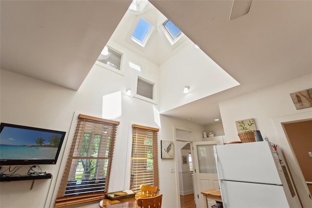 1001 E Crawford St, Tampa, FL 33604 - kitchen with freestanding refrigerator, a skylight, a high ceiling, and wood finished floors