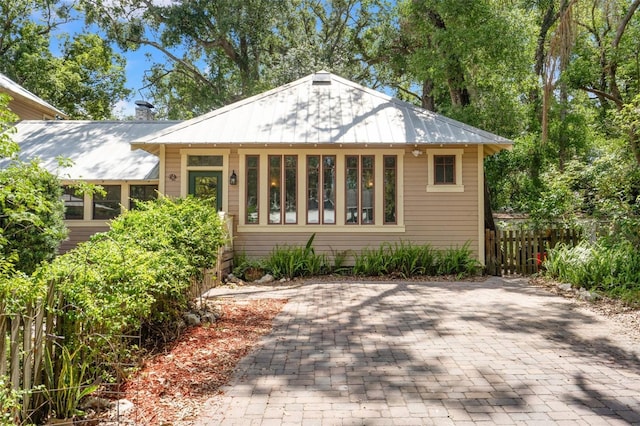 1001 E Crawford St, Tampa, FL 33604 - view of front of house featuring fence, metal roof, and a chimney