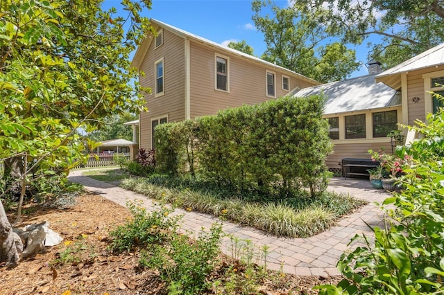 1001 E Crawford St, Tampa, FL 33604 - view of side of property featuring a chimney and fence
