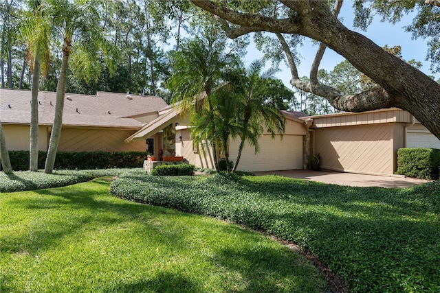 3071 Bolt Dr, Palm Harbor, FL 34685 - view of green lawn with a garage