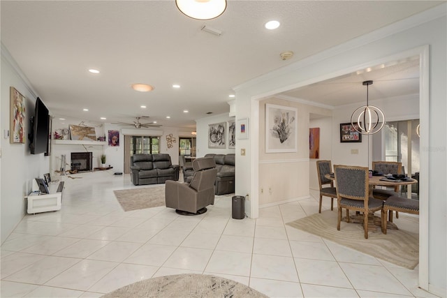 3071 Bolt Dr, Palm Harbor, FL 34685 - living room featuring crown molding, light tile patterned flooring, ceiling fan, recessed lighting, and a large fireplace