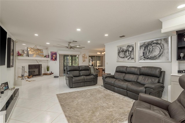 3071 Bolt Dr, Palm Harbor, FL 34685 - living area featuring recessed lighting, a premium fireplace, a ceiling fan, light tile patterned flooring, and crown molding