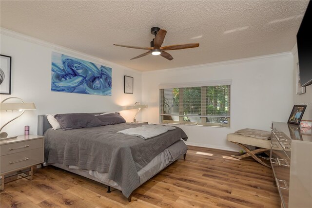 3071 Bolt Dr, Palm Harbor, FL 34685 - bedroom with ornamental molding, wood finished floors, a textured ceiling, baseboards, and a ceiling fan