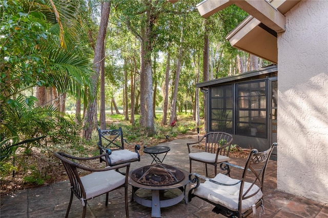 3071 Bolt Dr, Palm Harbor, FL 34685 - view of patio / terrace with a sunroom and a fire pit