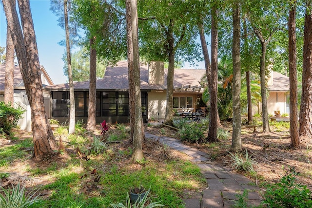 3071 Bolt Dr, Palm Harbor, FL 34685 - rear view of property with a sunroom and a shingled roof