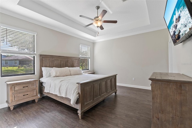 4690 Coachford Dr, Wesley Chapel, FL 33543 - bedroom with a tray ceiling, dark wood-style flooring, baseboards, ornamental molding, and ceiling fan