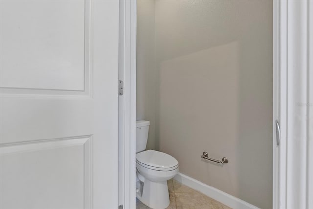4690 Coachford Dr, Wesley Chapel, FL 33543 - bathroom featuring toilet, tile patterned flooring, and baseboards